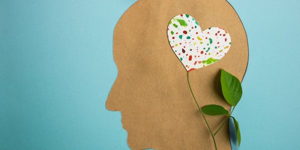 World Heart and Mental Health Day. Paper Cut as Human Head with Leaf Tree and Colorful Heart Shape Flower inside the Brain. Psychology, Creativity and Positive Mind Concept
