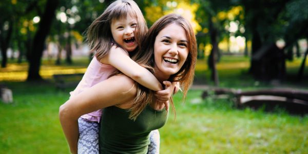 Little girl with special needs enjoy spending time with mother in nature